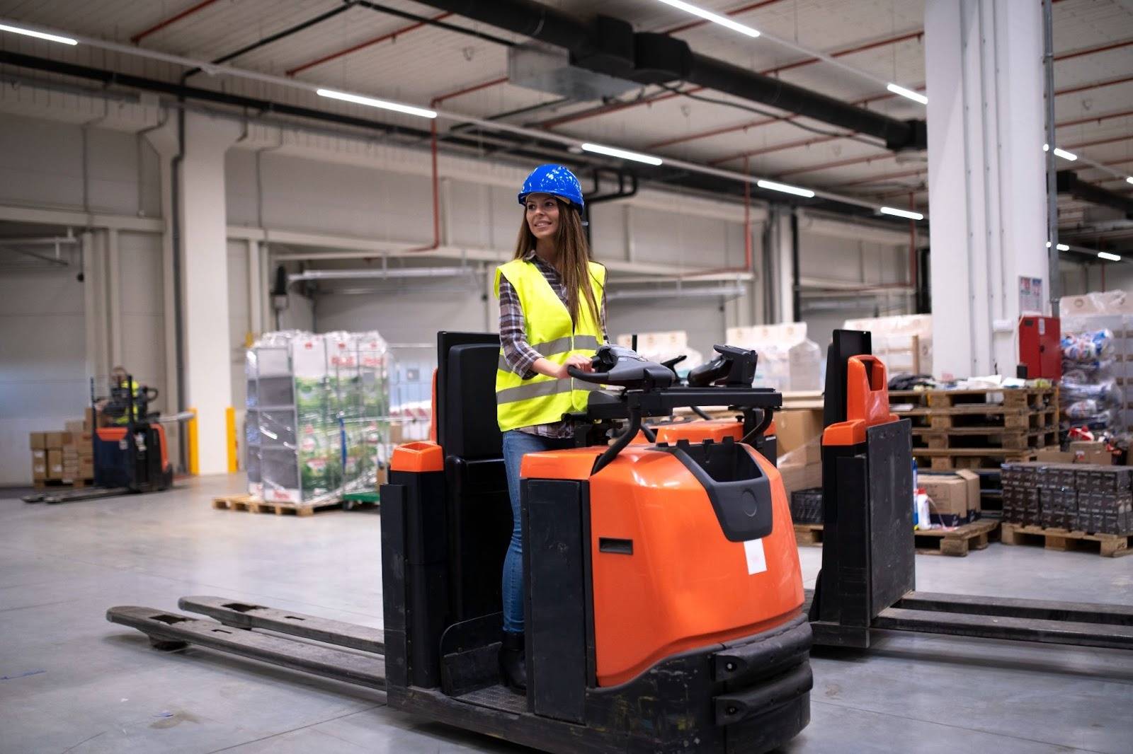 Warehouse worker operating a modern forklift inside a logistics facility, showcasing equipment provided by professional Forklift Suppliers in Dubai.